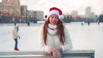 Young smiling woman ice skating inside on ice rink. video