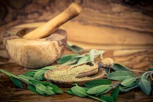 Sage leaves on olive wood photo