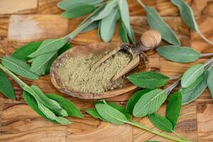 Sage leaves on olive wood photo