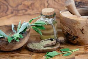 Sage leaves on olive wood photo