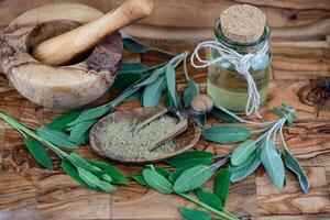 Sage leaves on olive wood photo