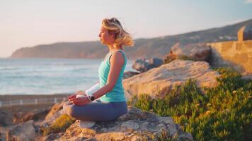 a woman is doing yoga on the beach video