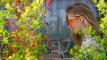 a woman in glasses sitting at a table with a laptop. remote working concept video