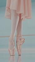 Ballerina's feet in ballet shoes. Close up of ballet dancer's legs in pointe. Woman practices exercises.. Unrecognizable professional lady shows classic pas. Vertical format for the phone. video