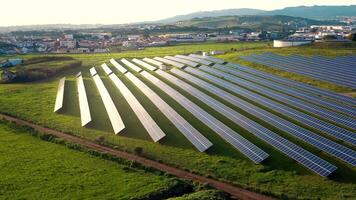 Aerial view of solar panels stand in a row in the fields. video