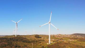 wind turbines on a hillside with blue sky video