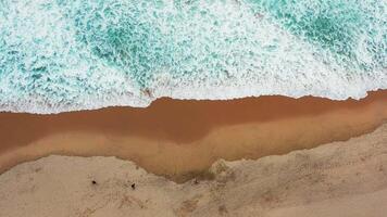 Aerial view of wave on the beach with sand and turquoise waves video