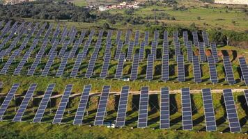 aéreo ver de solar paneles estar en un fila en el campos. video