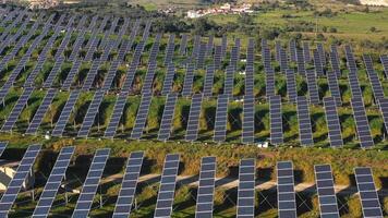 Aerial view of solar panels stand in a row in the fields. video