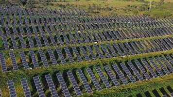 Aerial view of solar panels stand in a row in the fields. video