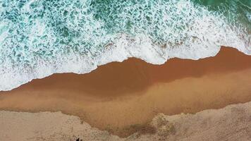 Aerial view of wave on the beach with sand and turquoise waves video