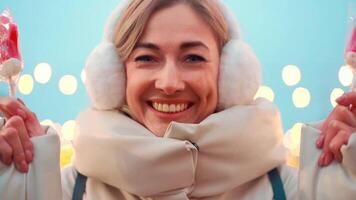 a woman in a winter coat standing close to ice rink video