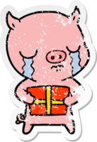 distressed sticker of a cartoon pig crying over christmas present png