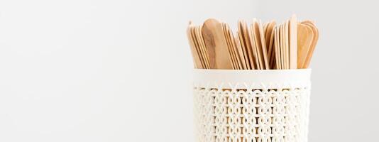 Sticks of wood for wax in white basket isolated on white background with copy space. photo