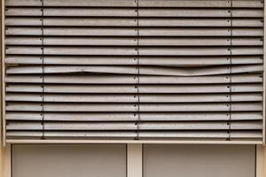 window blinds are broken and the slats are bent photo