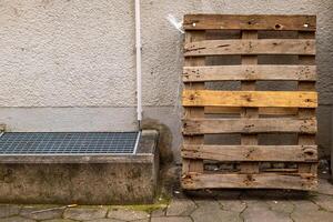 an old wooden euro pallet on the wall of a house photo