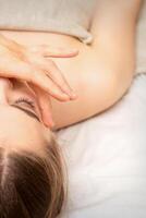 Face massage with fingers of a masseur. Female facial skin care at a beauty spa salon. photo