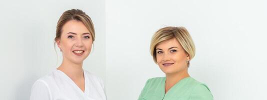 Portrait of two cosmeticians smiling against a white background. Copy space. photo