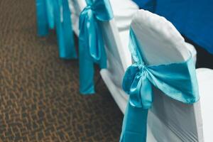 Wedding chair decorate with a blue bow photo