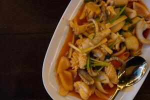 Stir fried squid with salted egg york. Delicious Thai dish. photo
