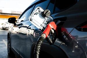 Car fueling at gas station. Refuel fill up with petrol gasoline. photo