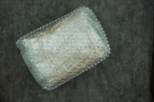 Paper box wrapped in plastic bubble wrap photo