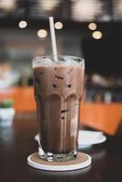 Chocolate milk drink glass with paper straw photo