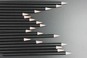 Black pencils on the matte black background. photo