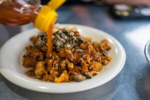 Phuket food small oyster omelet with taro it called O-Tao eating with spicy sauce photo