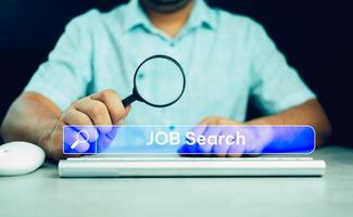 Man holding magnifying glass with job search in search bar. photo