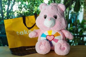 Bangkok, Thailand - April 12, 2024 Cute a pink Care Bears. Teddy bear dolls Care Bears, photo