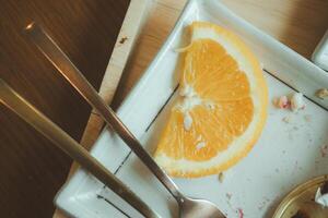 Sliced lemon on a dessert plate after eating photo