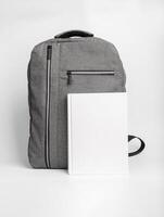 Book cover mockup, textbook mock up at school bag, backpack photo