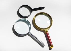 Glass magnifies many mysteries. Three lenses zoom background, investigate, study. Curiosity controls photo