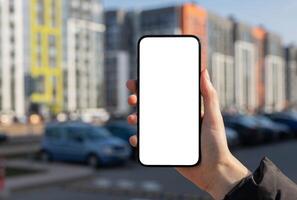 Holding mobile phone screen, blank smartphone display mockup, blurred city building photo