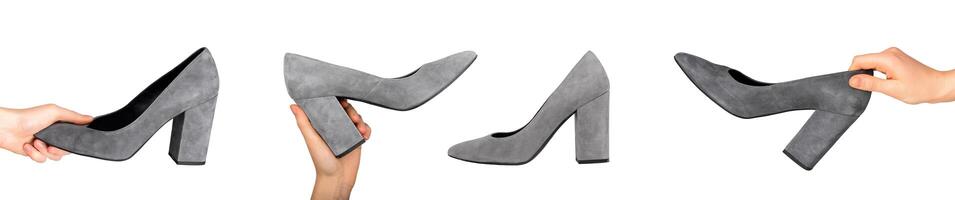 Hand holding women suede shoe with, heeled footwear, isolated on white photo