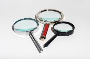 Glass zoom tool for research and analysis. Transparent lens to find details. Business concept of photo