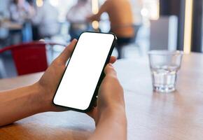 A woman holds a smartphone, showing a blank screen. Perfect for digital advertising or app display photo