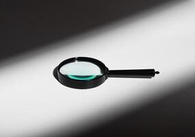 Abstract concept of light and shadow. Glass magnifier lens, transparent handle. Minimal optics photo