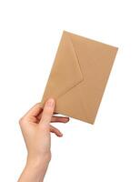 Brown kraft paper envelope in hand isolated on white background photo