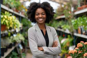 Black Business Woman in a Garden Center Surrounded by Greenery photo