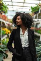 Black Business Woman in a Garden Center Surrounded by Greenery photo