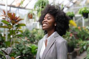 Black Business Woman in a Garden Center Surrounded by Greenery photo