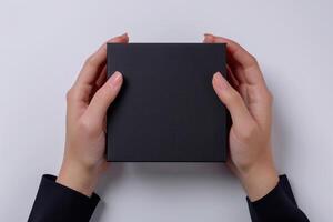 Female hands open empty black box in studio. photo