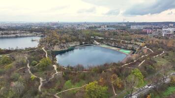 Urban Oasis. Aerial View of Quarry Lake Park, Lush green park with quarry lake in a city setting, as seen from above. video