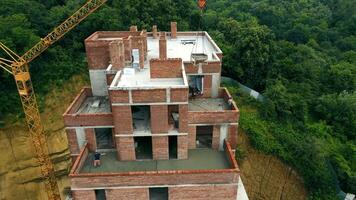 Aerial view Construction of a multi-storey brick house. Builders pour concrete on the top floor. Construction workers are building a house video