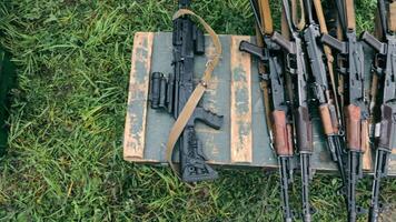 Army soldiers unload boxes of ammunition. Military assistance with ammunition, submachine guns and rifles. A serviceman transfers his weapon. video