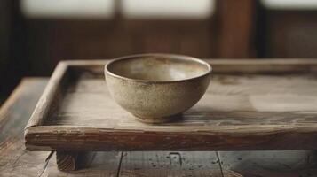 Handmade ceramic bowl on a wooden tray photo