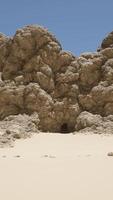 A large rock formation in the middle of a desert video