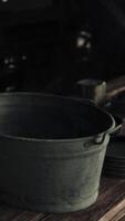 A metal bucket on a wooden table video